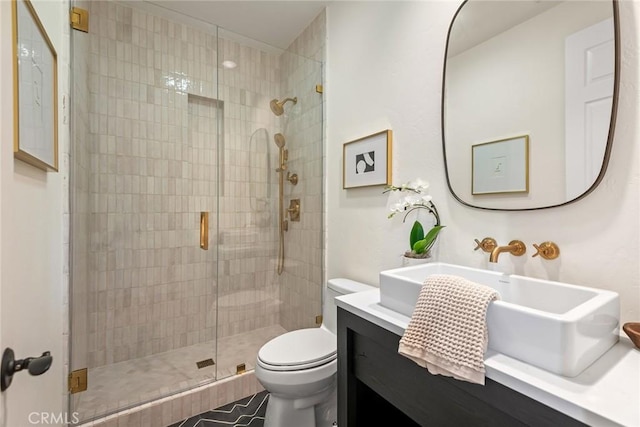 bathroom with a shower with door, vanity, and toilet