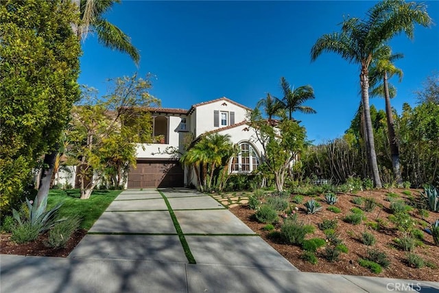 mediterranean / spanish-style home featuring a garage