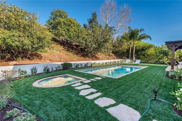 view of pool featuring a yard and an in ground hot tub