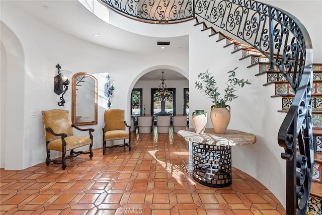 entryway featuring a towering ceiling