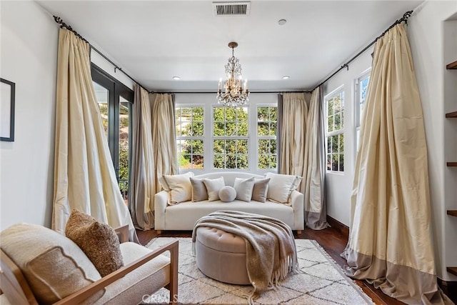 sunroom / solarium featuring an inviting chandelier