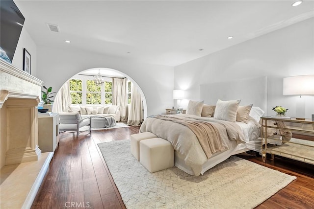 bedroom featuring dark hardwood / wood-style floors and a chandelier