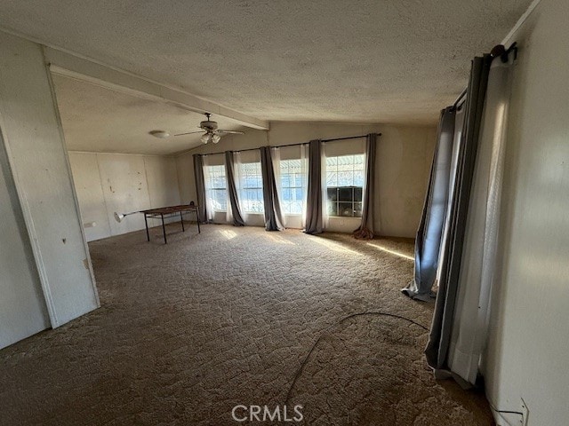 miscellaneous room with ceiling fan, lofted ceiling with beams, a textured ceiling, and carpet flooring