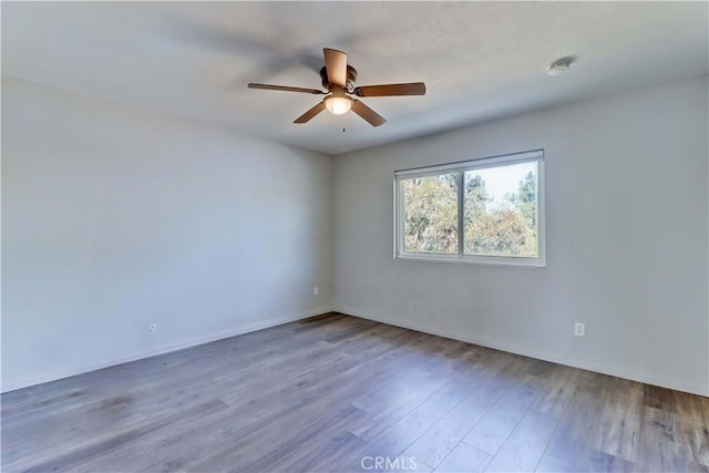 empty room featuring ceiling fan and hardwood / wood-style floors