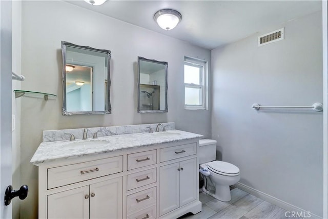 bathroom with vanity, hardwood / wood-style floors, and toilet