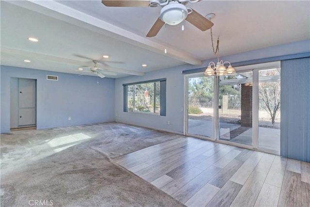 unfurnished room with ceiling fan with notable chandelier, beam ceiling, and light hardwood / wood-style flooring