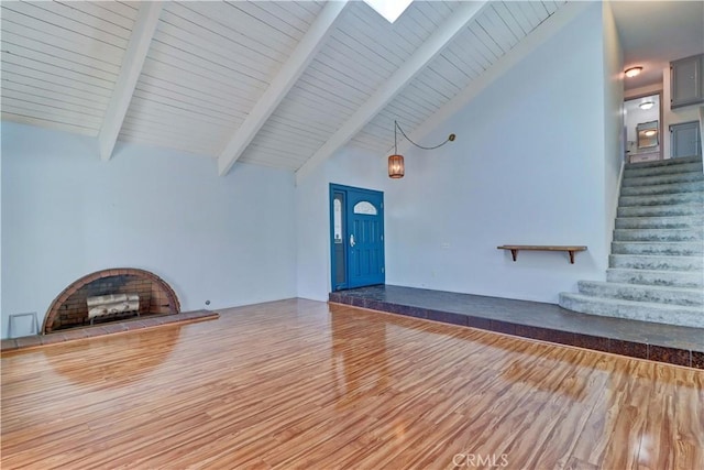 unfurnished living room featuring hardwood / wood-style flooring, high vaulted ceiling, and beam ceiling