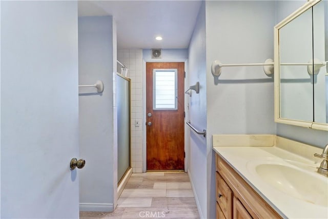 bathroom featuring vanity and an enclosed shower