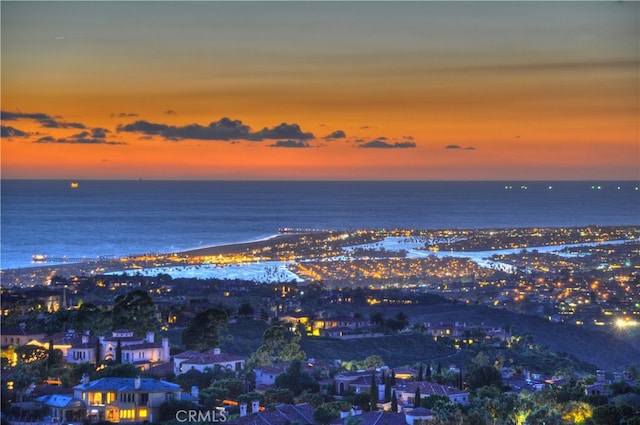 aerial view at dusk with a water view