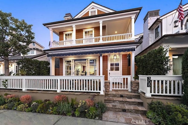 view of front of house featuring a porch and a balcony