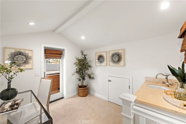 carpeted home office featuring lofted ceiling with beams and sink