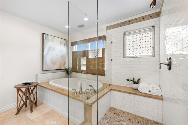 bathroom featuring tile patterned flooring and shower with separate bathtub