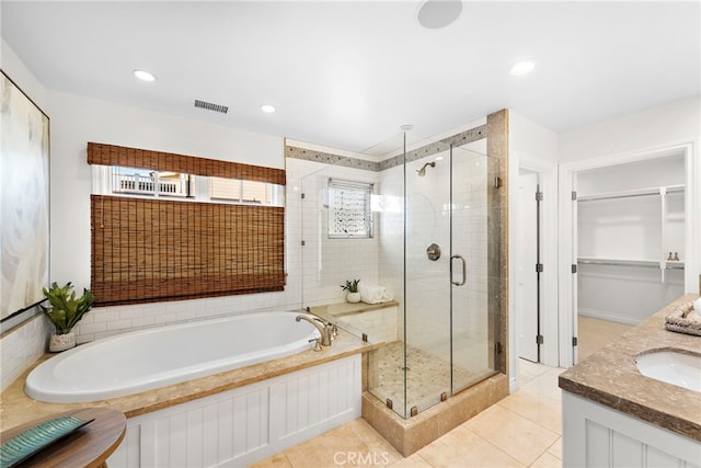 bathroom with independent shower and bath, vanity, and tile patterned floors