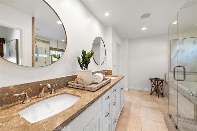 bathroom with tile patterned flooring, vanity, and walk in shower