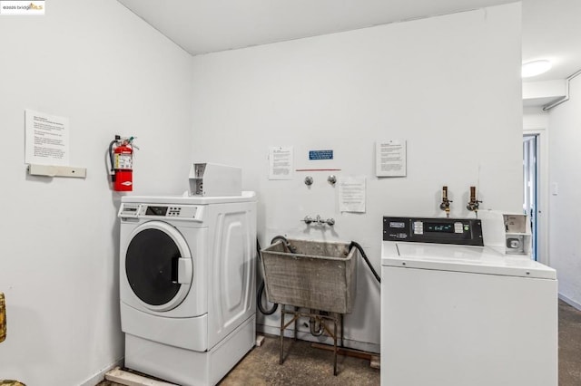 laundry room featuring sink and washer and clothes dryer