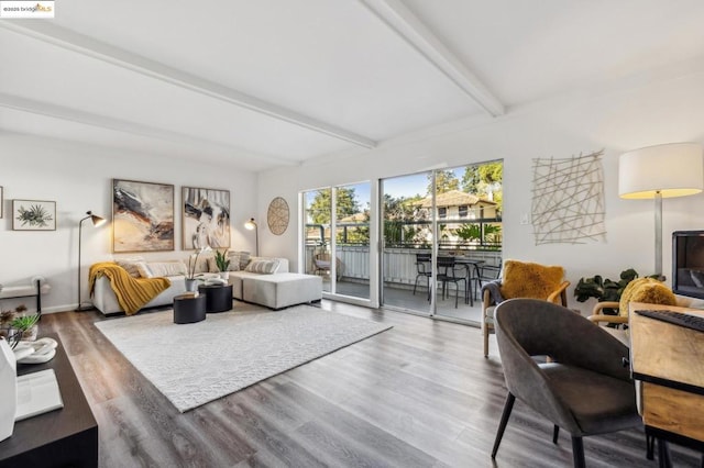 living room featuring beamed ceiling and wood-type flooring