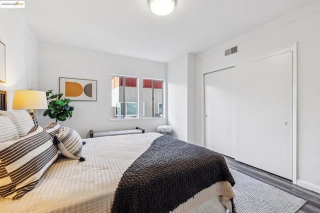 bedroom featuring dark wood-type flooring and a closet