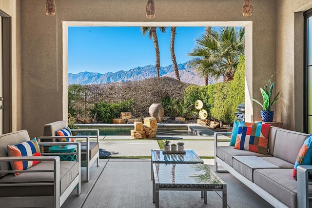 view of patio / terrace featuring a mountain view and an outdoor hangout area