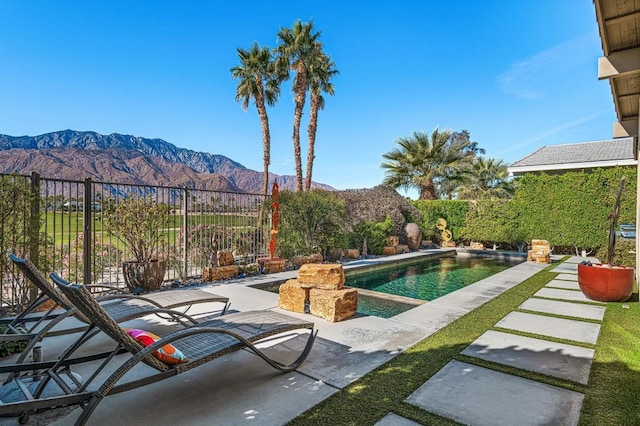 view of pool featuring a mountain view and a patio