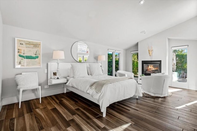 bedroom featuring multiple windows, lofted ceiling, and dark wood-type flooring