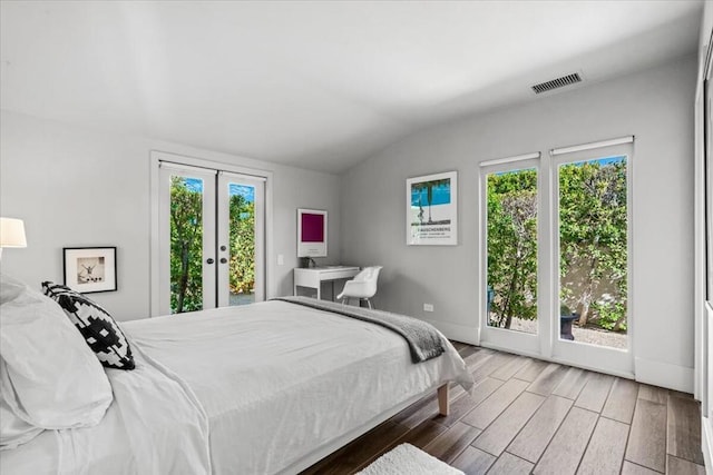 bedroom with french doors, lofted ceiling, and access to exterior