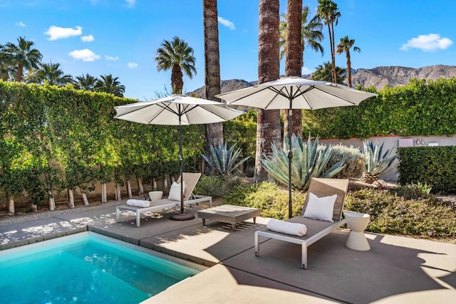 view of pool with a mountain view and a patio