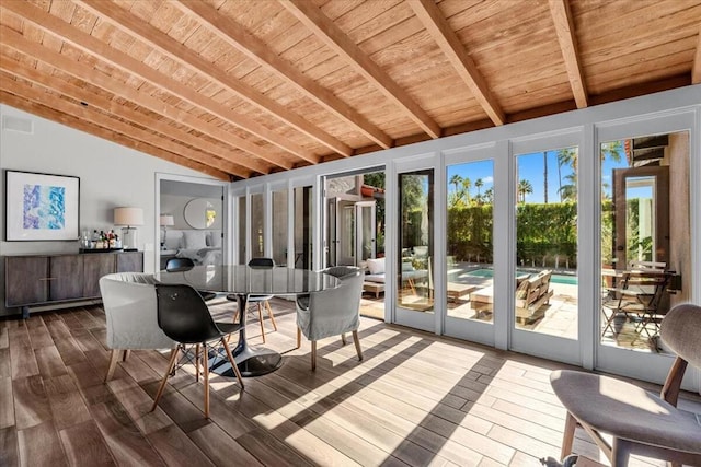 unfurnished sunroom with wood ceiling, plenty of natural light, and lofted ceiling with beams