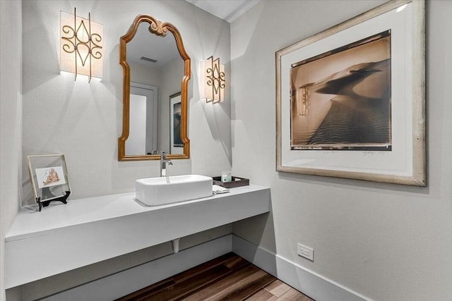 bathroom with hardwood / wood-style flooring and vanity