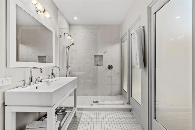 bathroom with tile patterned floors and a tile shower