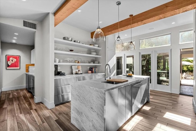 kitchen featuring built in features, dishwasher, white cabinetry, hanging light fixtures, and a spacious island