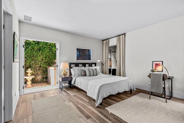 bedroom with hardwood / wood-style flooring