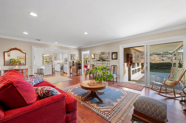 living room featuring hardwood / wood-style flooring and ornamental molding