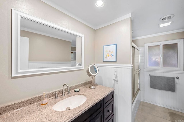 bathroom with vanity, crown molding, tile patterned floors, and shower / bath combination with glass door