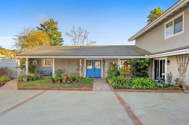 view of front facade featuring fence and stucco siding