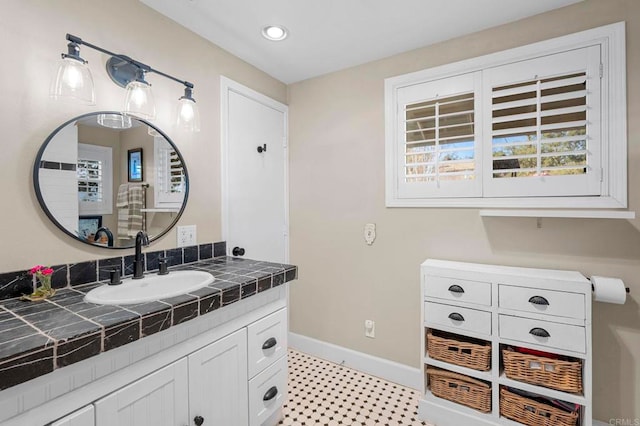 bathroom with recessed lighting, vanity, and baseboards