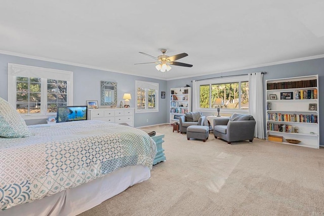 carpeted bedroom with ceiling fan, ornamental molding, and baseboards