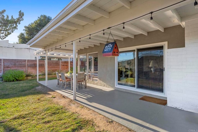 view of patio featuring fence