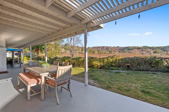 view of patio with outdoor dining space and a pergola