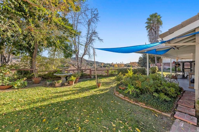 view of yard with fence and a patio