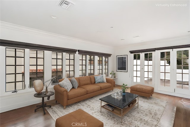 living room with ornamental molding and light wood-type flooring