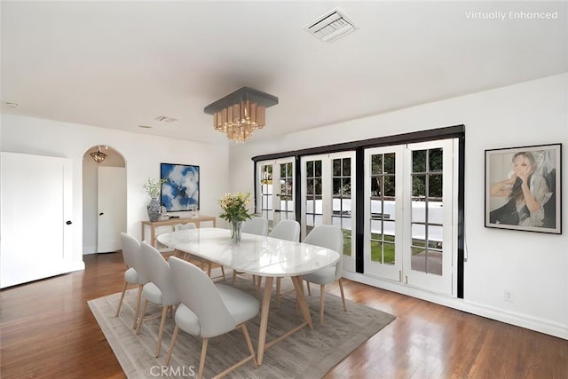 dining room featuring dark hardwood / wood-style flooring and a chandelier