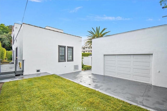 view of property exterior with a yard and a garage