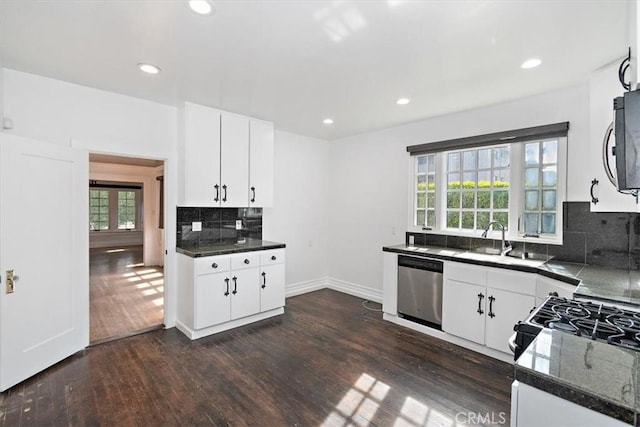 kitchen with white cabinetry, a wealth of natural light, and appliances with stainless steel finishes