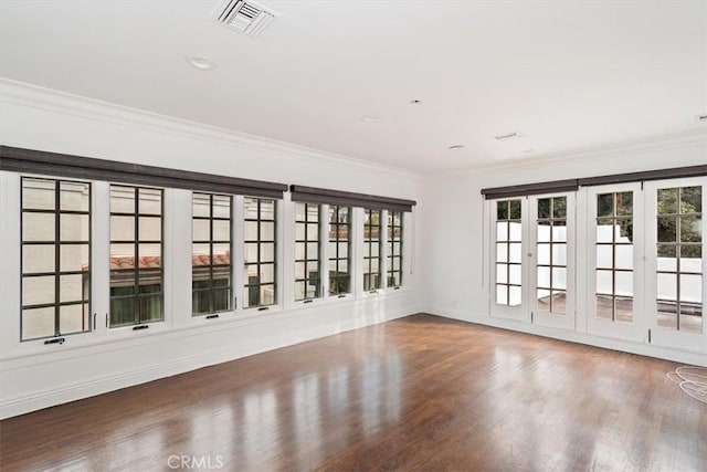 unfurnished room with crown molding and wood-type flooring