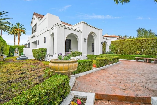 view of property exterior with a patio