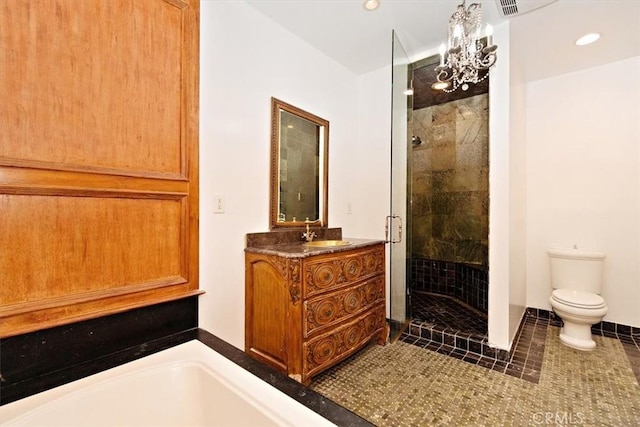 bathroom featuring vanity, a shower with shower door, tile patterned floors, and toilet