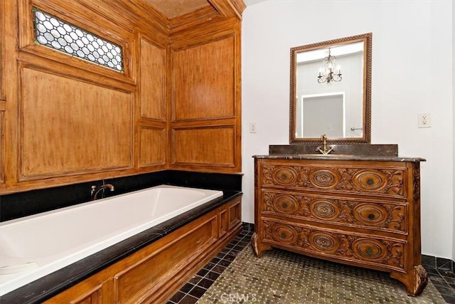 bathroom with tile patterned floors, a bathtub, and vanity