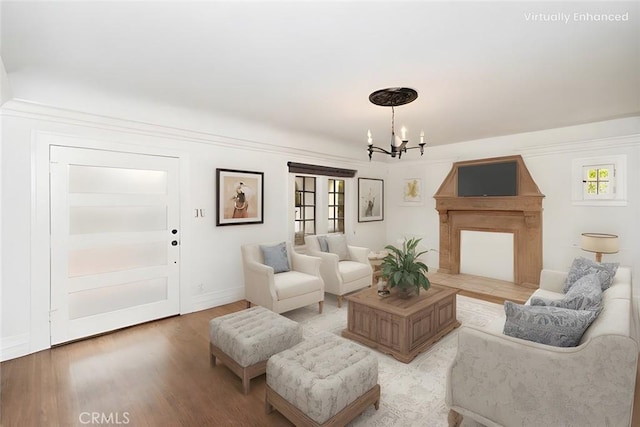 living room featuring a chandelier and light hardwood / wood-style flooring