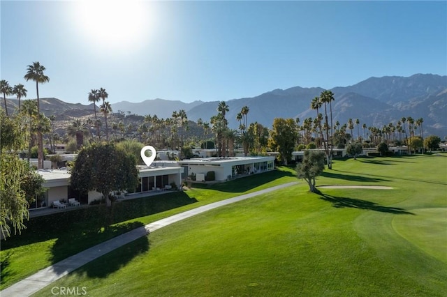 view of property's community featuring a mountain view and a lawn