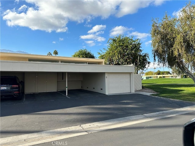 view of parking / parking lot featuring a carport and a lawn